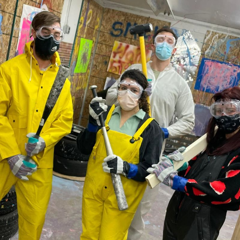 friends in a rage room with full equipment at unity rage room